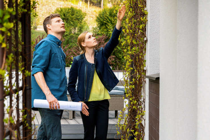 Couple checking out their new home Couple examining exterior of house | New Homeowners Checklist | An Post Insurance