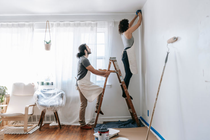 Couple painting new house Couple painting living room | To-Dos for New Homeowners | An Post Insurance